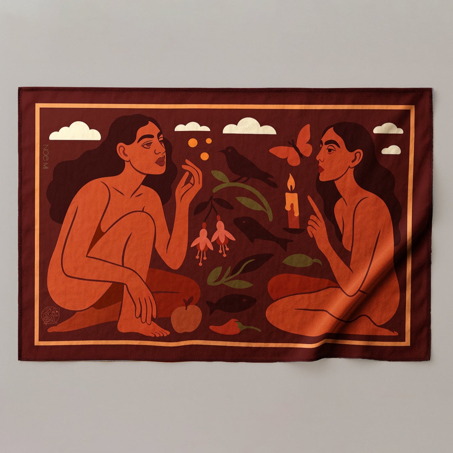 a colorful silk or chiffon pareo/sarong of two figures with nature elements on a fabric background