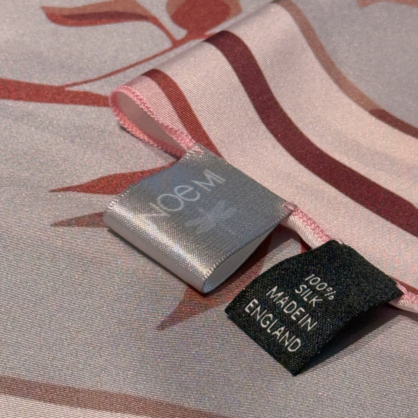 NOE MI designer scarf, Ginger Lace artwork in soft pink and red tones, feminine surrealist storytelling with symbolic botanical and celestial motifs.