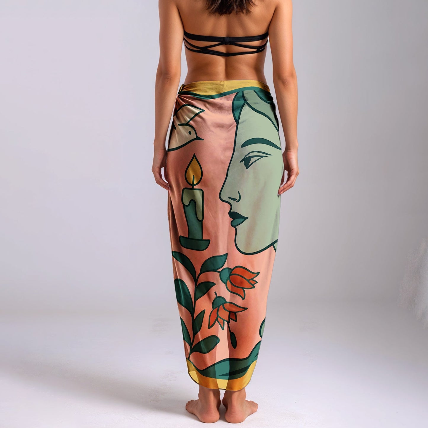 Woman wearing a colorful silk or chiffon pareo/sarong with artistic design on a plain background