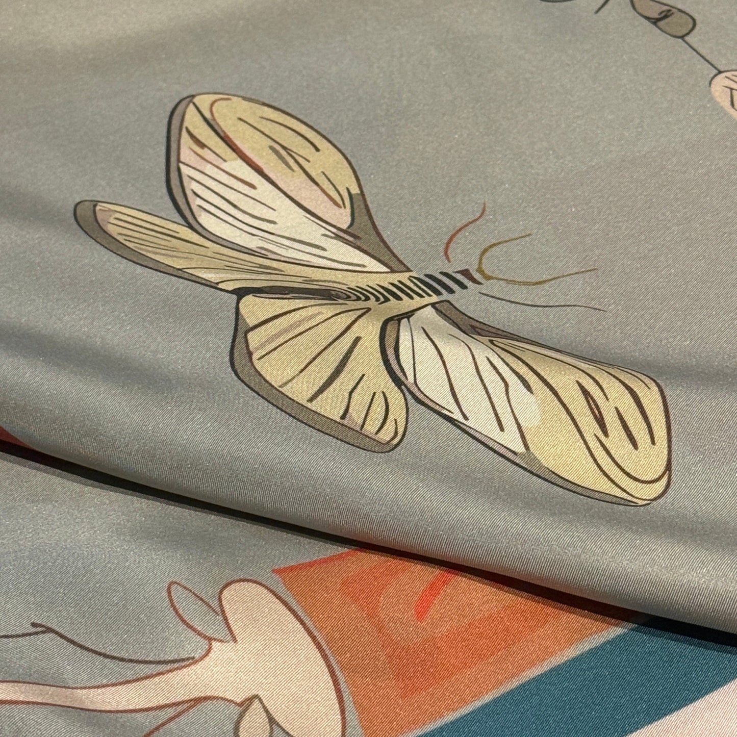 NOE MI collectible silk scarf, square luxury accessory with surreal feminine figure, candle, dragonfly, and navigation motifs in soft hues.