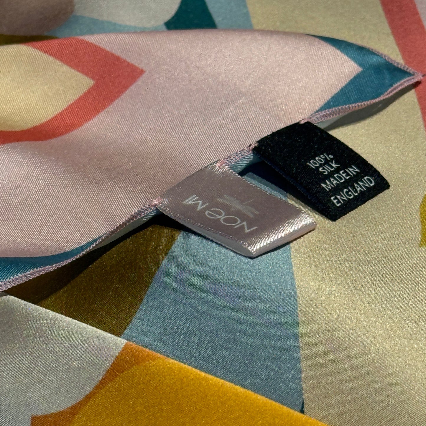 Two of a Kind silk scarf from NOE MI, collectible square scarf with feminine surreal design, symbolic fruits, serpent, and celestial motifs.