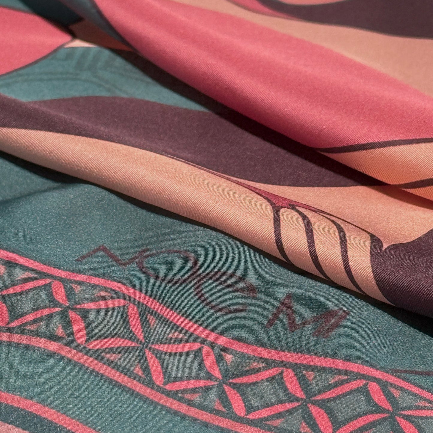NOE MI Soft Chains silk scarf, square luxury scarf in dusty rose and teal blue, featuring three feminine figures with symbolic apple, butterfly, and bird motifs.