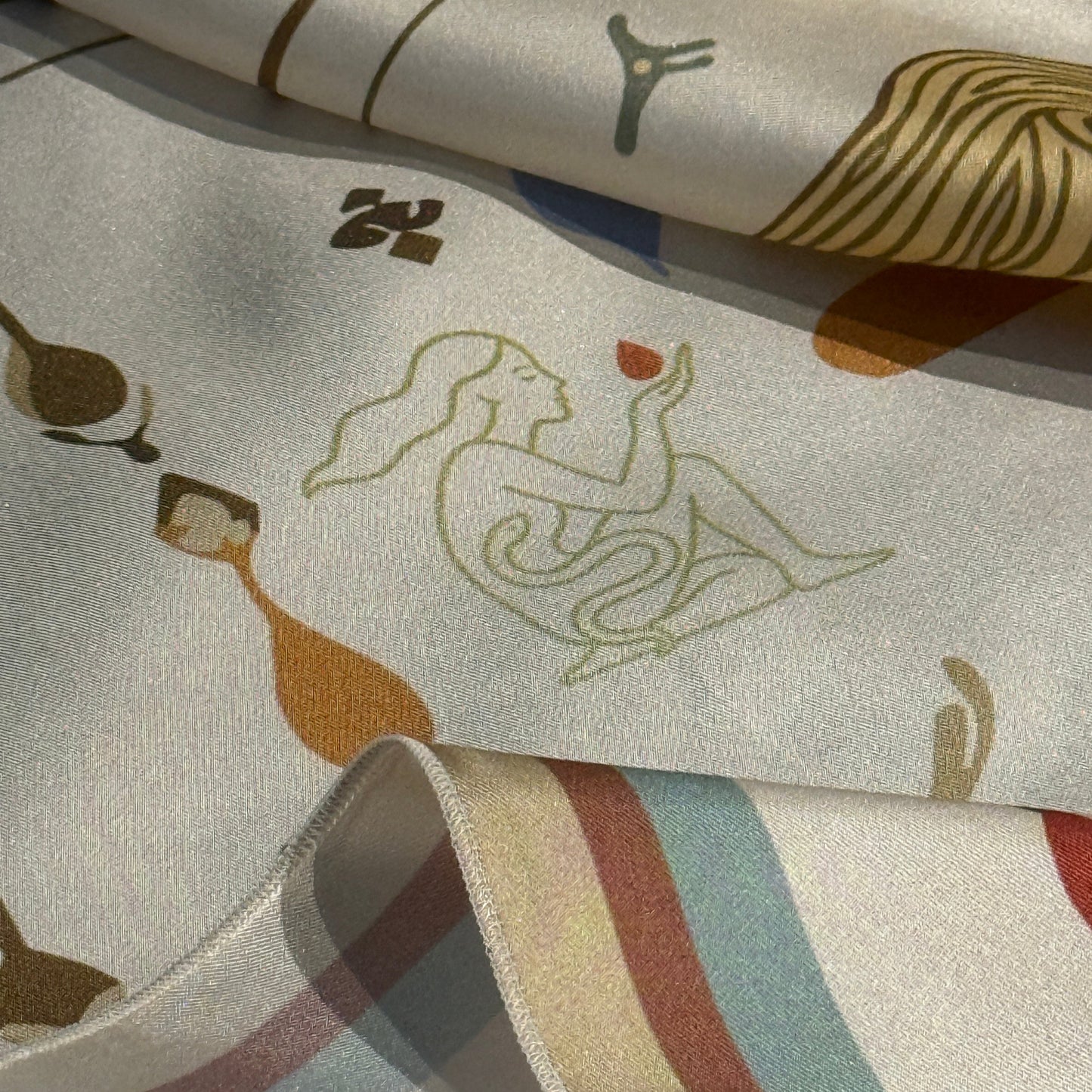 NOE MI The Navigator silk scarf, luxury square scarf in cream, black, and gold with red accents, featuring feminine surreal artwork with compass, dragonflies, and symbolic motifs.