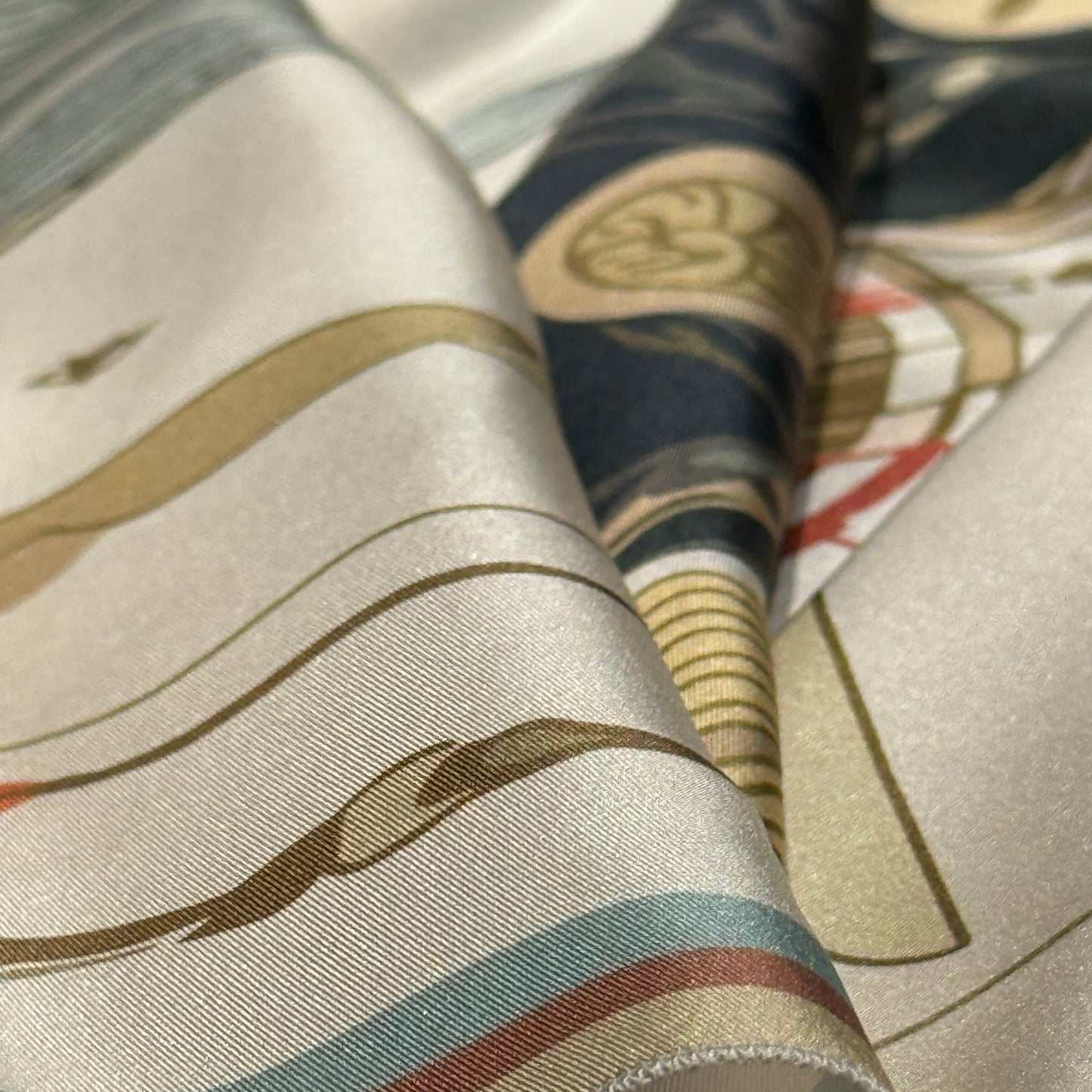 NOE MI luxury silk scarf titled The Navigator in Sunlight is a statement accessory featuring a graceful woman, winged dragonfly motifs, subtle clouds, and ornamental details that elevate everyday styling with artistic elegance.