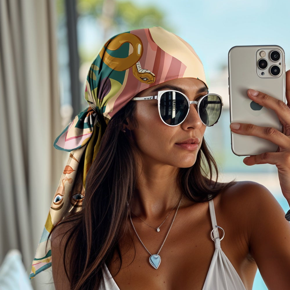 Woman in a white bikini taking a selfie by a pool wearing an luxury art silk twill scarf as a bandana
like hermes and dior