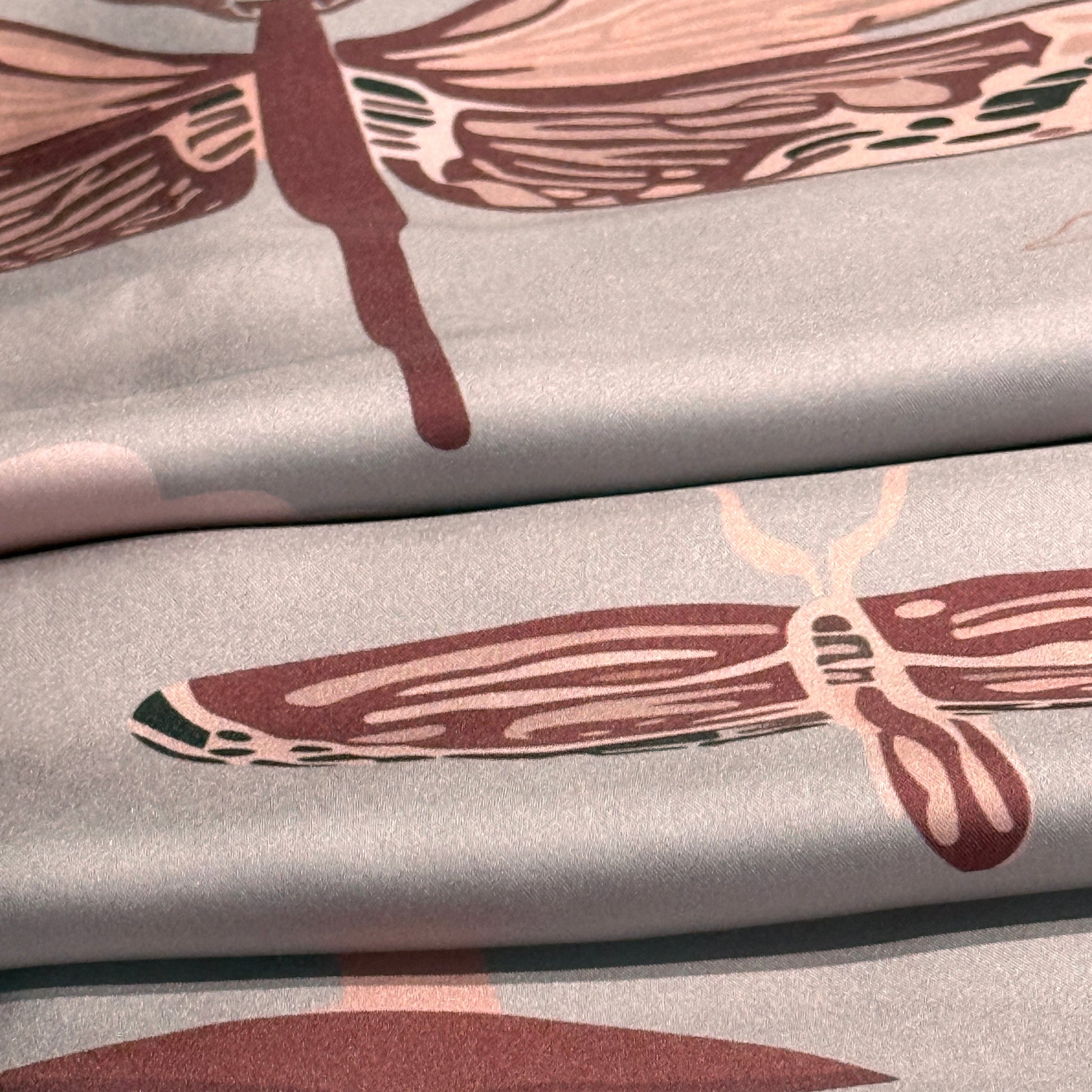 NOE MI Ginger Lace square silk scarf, luxury fashion accessory with symbolic feminine portrait, dragonflies, and floral details in pink and cream hues.