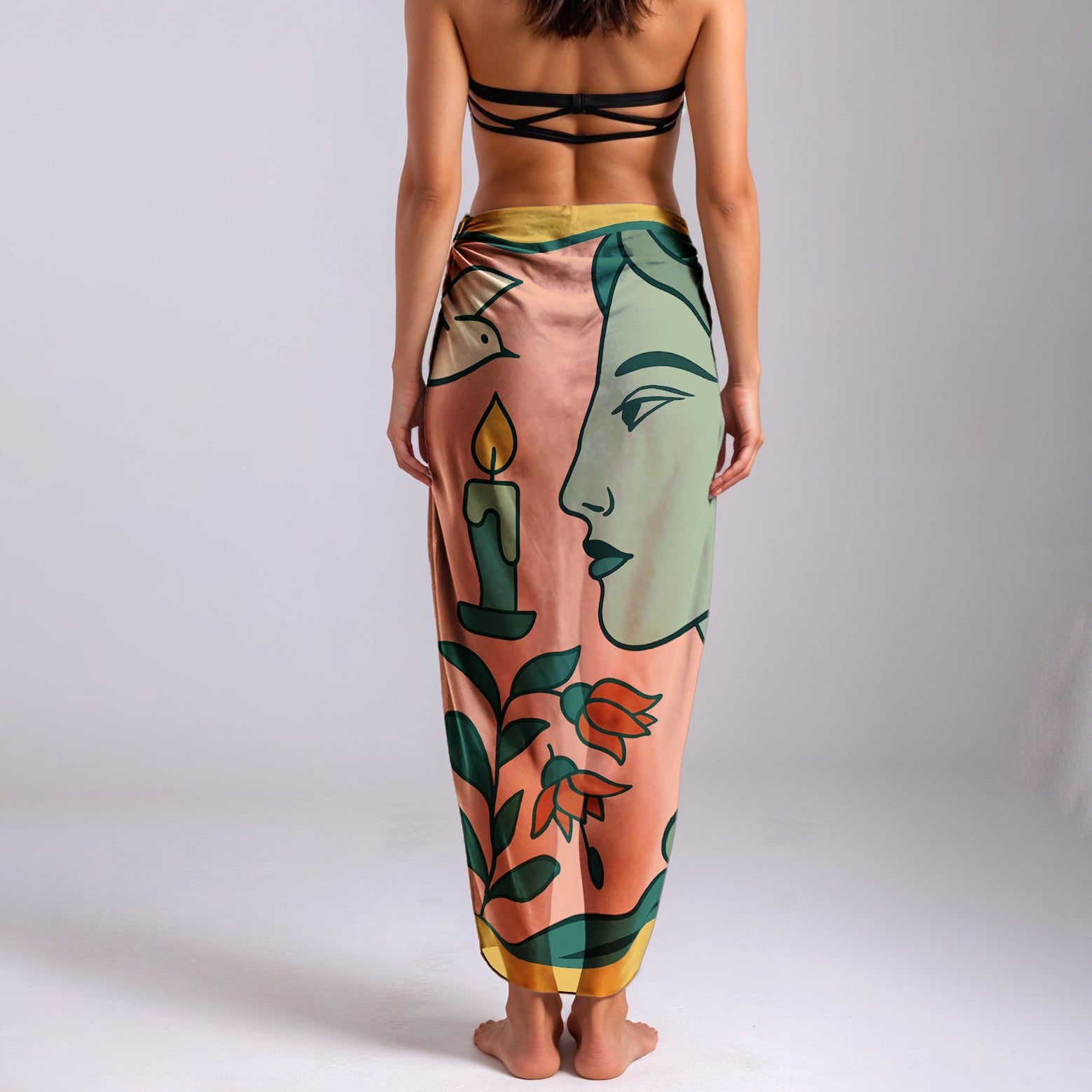 Woman wearing a colorful silk or chiffon pareo/sarong with artistic design on a plain background