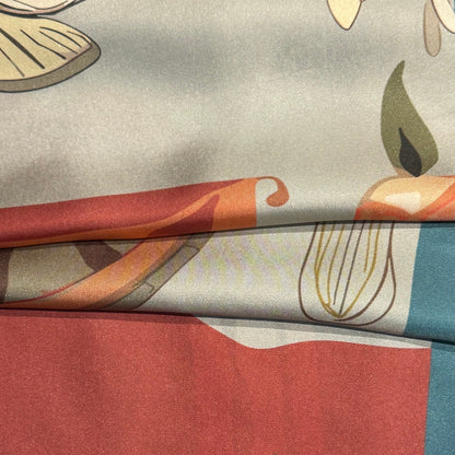 Artistic silk scarf from NOE MI, square luxury accessory with surreal feminine figure and symbolic elements in sage, red, and cream tones.