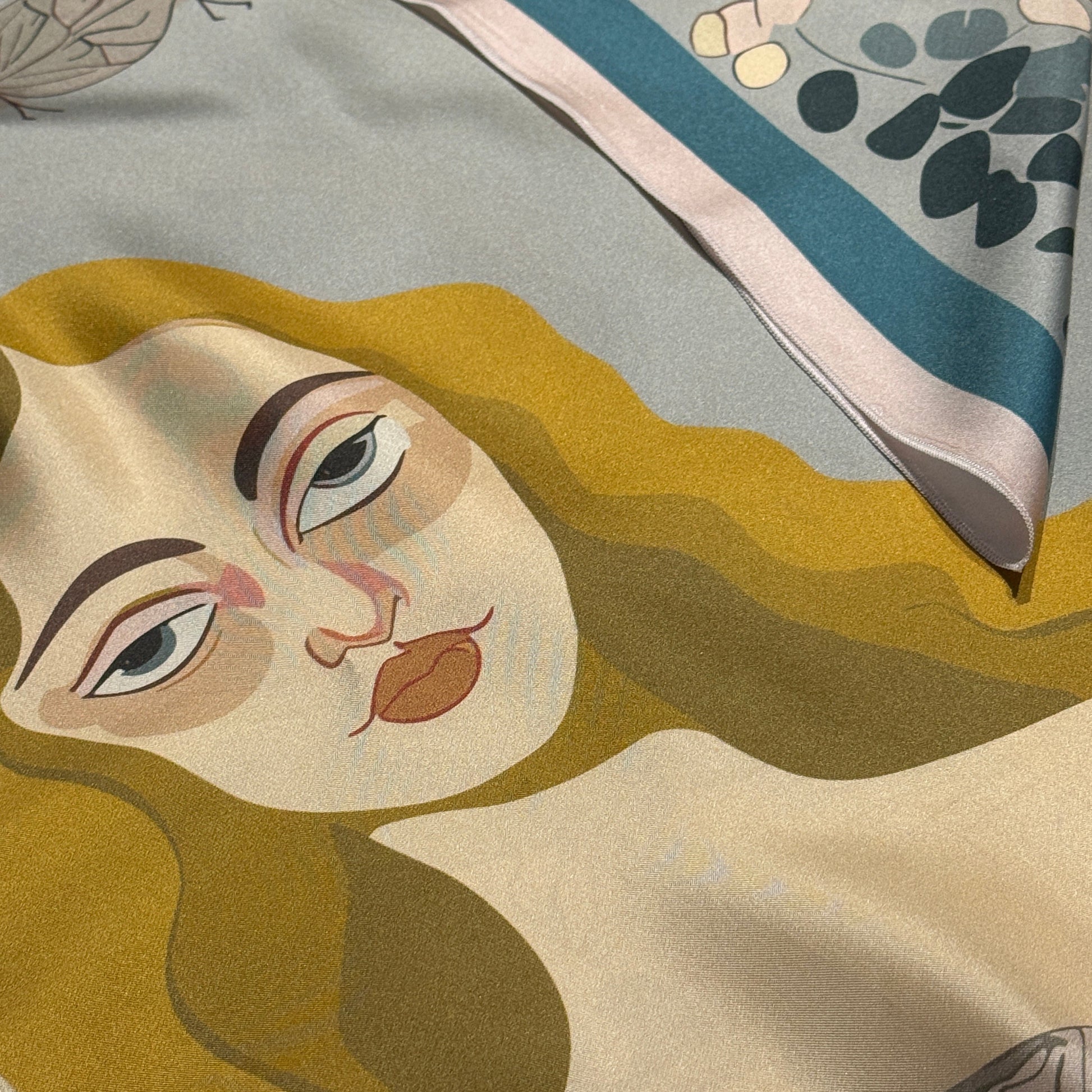 Designer silk scarf by NOE MI, luxury square scarf with surreal storytelling, feminine artwork in green, red, and cream tones.