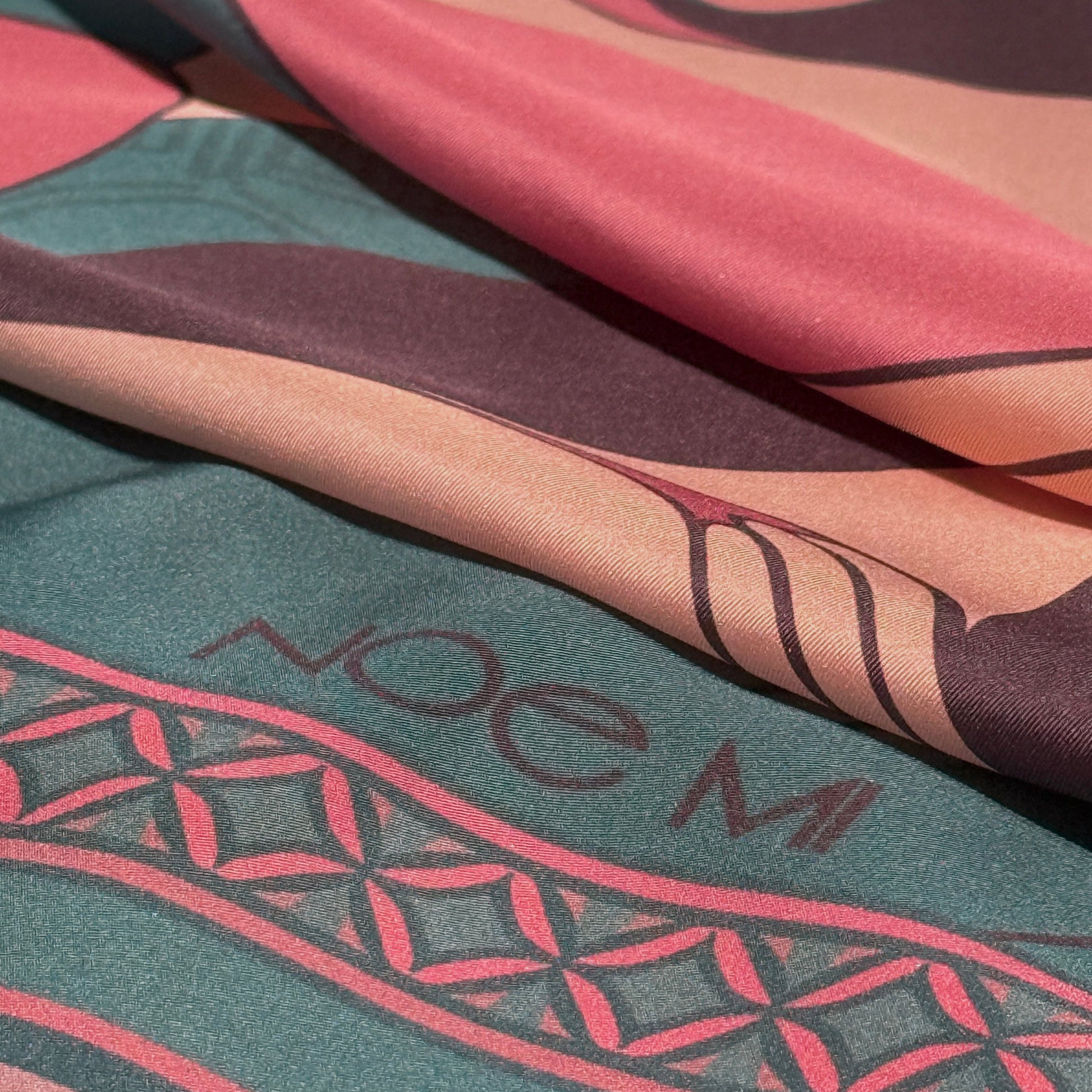 NOE MI Soft Chains silk scarf, square luxury scarf in dusty rose and teal blue, featuring three feminine figures with symbolic apple, butterfly, and bird motifs.
