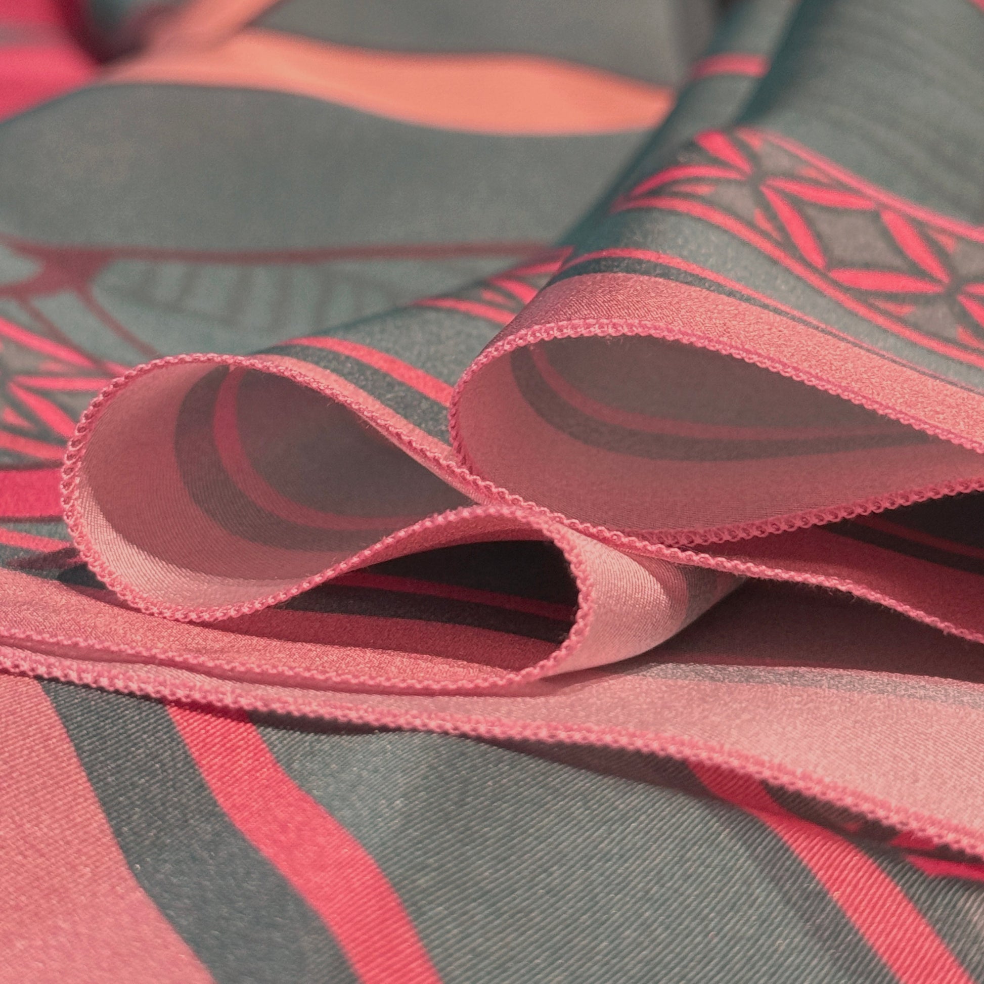 Soft Chains silk scarf from NOE MI, artistic square scarf with three women, surreal motifs, and symbolic storytelling, in rose and teal palette.