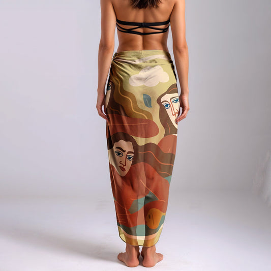 Woman wearing a colorful silk or chiffon pareo/sarong with artistic designs on a plain background