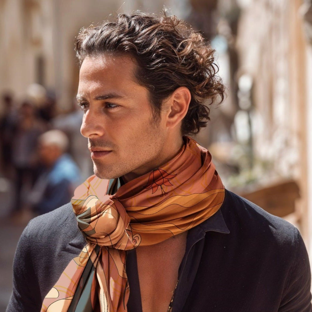 Man wearing a patterned NOEMI SILK TWILL scarf in an urban setting